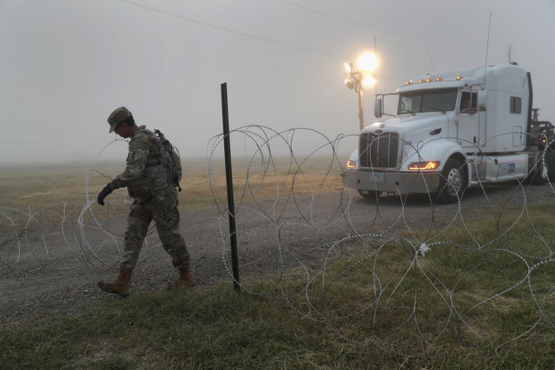 A soldier in Donna, Texas, moving barbed wire near the U.S.-Mexico border.